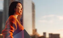 Close-up of two business professionals shaking hands in a modern office setting