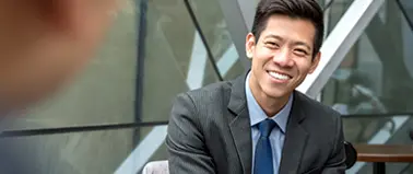 Smiling Asian businessman in a suit during a job interview